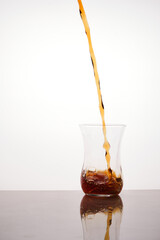 Continuous tea flow pours to traditional turkish tea glass. Men's health concept. Absence of genitourinary system diseases. Treatment of prostate adenoma or prostatitis