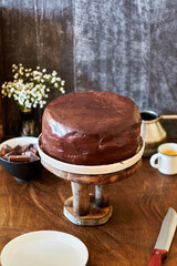 Dark chocolate cake. Side view. Wooden background.