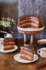 Dark chocolate cake. Side view. Wooden background.