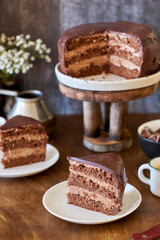 Dark chocolate cake. Side view. Wooden background.