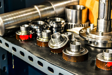 Metal grips and threaded adapters in a repair shop.