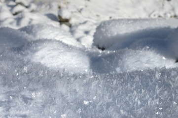 Large crystals on the snow surface on a sunny winter day. Winter background