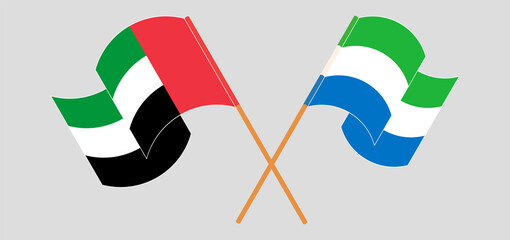 Crossed and waving flags of the United Arab Emirates and Sierra Leone
