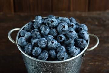 Wet fresh Blueberry background. close up with selective focus and water droplets. Concept of healthy and dieting eating