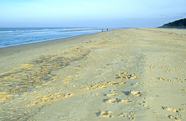 Norfolk UK coast line with blue sea and yellow beach. 
