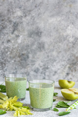 Smoothie with spinach and apple on a concrete background. Detox drink. The keto diet.