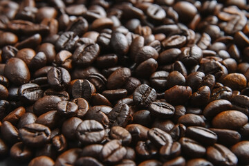 Coffee beans background. Brown roasted coffee beans. Closeup shot of coffee beans.  Fresh roasted coffee beans.