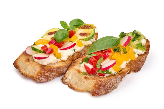Assorted bruschetta with various toppings, isolated on white background. High resolution image