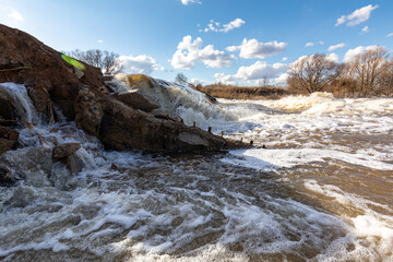 Powerful spring stream of water. Spring flood. Russian nature in spring. The destructive power of...