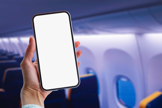 Girl Holding A Mock Up Smartphone With A Close-up With A White Screen Inside The Plane.