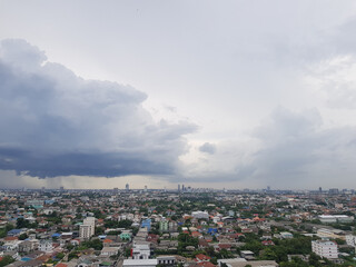 Naklejka premium Rain clouds are falling far in the city.