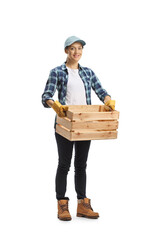 Full length portrait of a female farmer worker carrying an empty crate