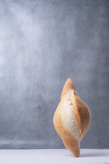 balancing bread on a table on a gray background