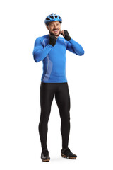 Full length portrait of a young male cyclist putting on a helmet and smiling