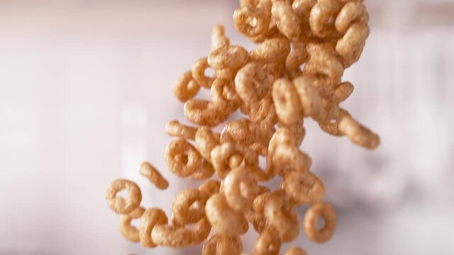 Crunchy Circle-Shaped Whole Grain Cereals Falling Down in Slow Motion and Macro (Phantom Flex)
