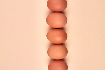 Vertical stack made of brown eggs.