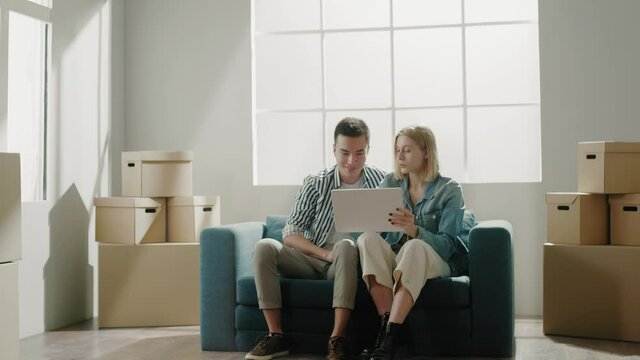 Couple enjoys apartment purchase and discusses furniture