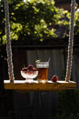 Cup of tea and wild strawberries on a wooden background
