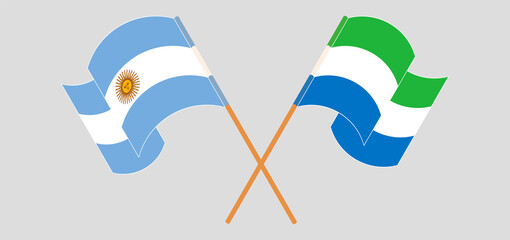 Crossed and waving flags of Argentina and Sierra Leone