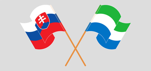 Crossed and waving flags of Slovakia and Sierra Leone