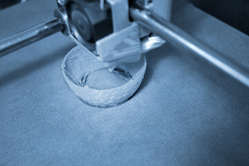 Work 3d printer close up. Printing 3D printer Object plastic On blue background.