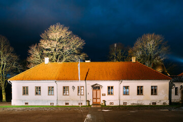 Fototapeta na wymiar Kuressaare, Saaremaa Island, Estonia. Museum Old House Building Near Episcopal Castle In Evening Blue Hour Night. Traditional Medieval Architecture, Famous Attraction Landmark