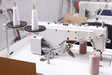 sewing machine with threads at the factory