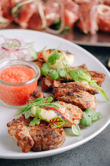 meat marinated for barbecue grilled and served on a white plate