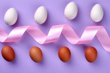 Composition of pink ribbon with chicken eggs.