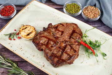 BBQ pork loin meat steak with potato. Dark background.