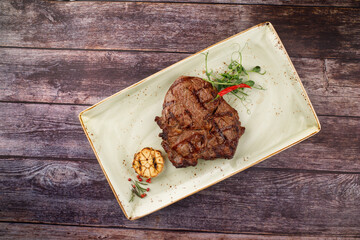 BBQ pork loin meat steak with potato. Dark background.