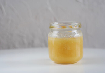 a glass jar with honey is on the table