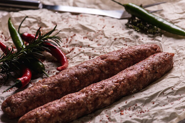 lyulya kebab close-up, meat dish for cooking in nature, barbecue lies on parchment light paper with...