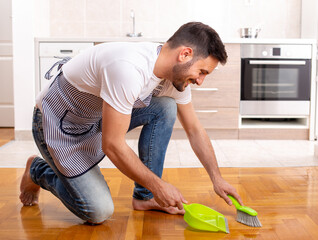 Man sweeping floor at home