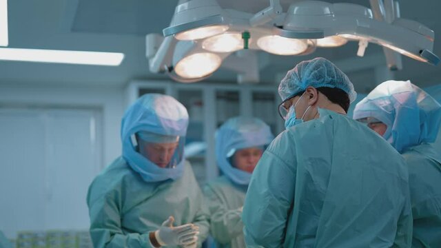 Process of trauma surgery operation. Group of surgeons wearing protective masks. Medical and saving lives concept