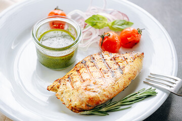 fried turkey fillet with sauce, grilled vegetables and pickled onions