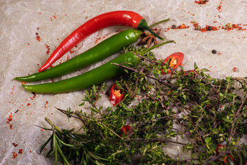Assorted brown meat with peppers and spices on a light parchment background. Seasonings for food....