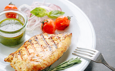fried turkey fillet with sauce, grilled vegetables and pickled onions