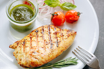 fried turkey fillet with sauce, grilled vegetables and pickled onions