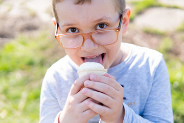 boy with glasses eating ice cream