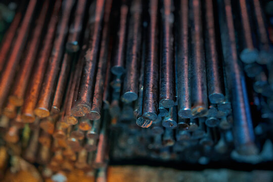 metal rods in mass, end view, metallurgy, steel, blurred background - Powered by Adobe