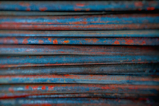 metal rods with rust in mass side view, metallurgy, steel, blurred background - Powered by Adobe