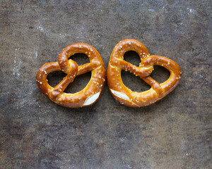 Salted pretzels on a brown background. German pastries.