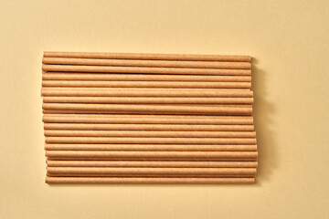 Paper straws on a beige background - zero-waste concept