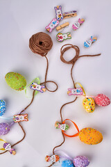 Vertical shot of motley easter eggs with thread.