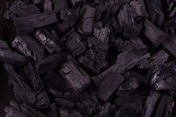 Black mineral coal as a cubic stone background. Coal scheme. Low key. Black coal