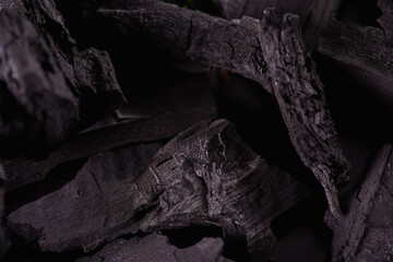 Black mineral coal as a cubic stone background. Coal scheme. Low key. Black coal
