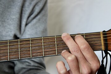 Fototapeta na wymiar left hand playing a G chord on guitar
