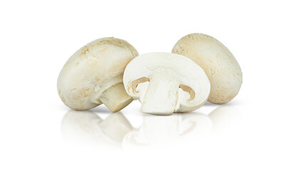 Two whole champignons and one in the cut are isolated on a white background