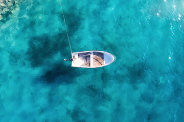 Fototapeta na wymiar Croatia. Summer. Aerial view of floating boat on blue Adriatic sea at sunny day. Boat on sea surface. Seascape from drone. Travel and leisure.